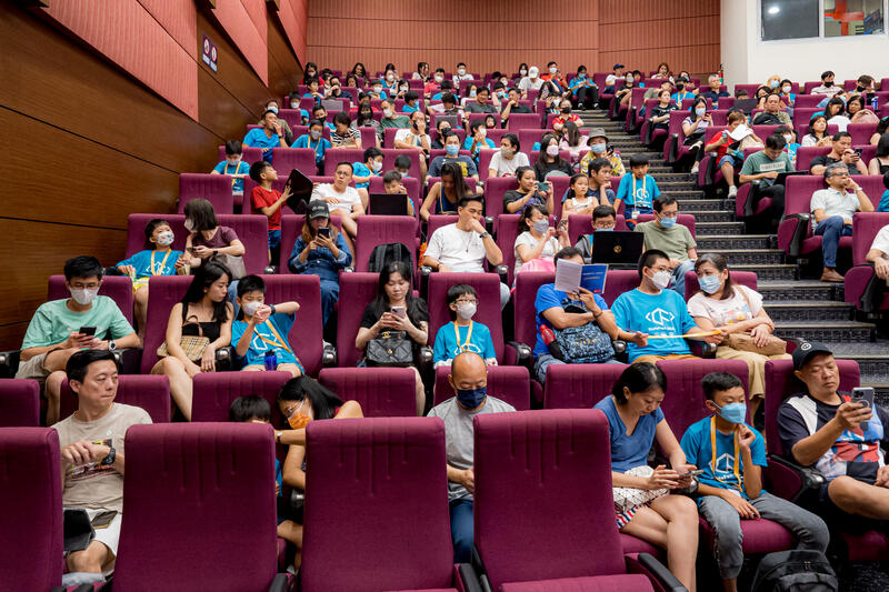Audience watching presentations at CodeFest auditorium