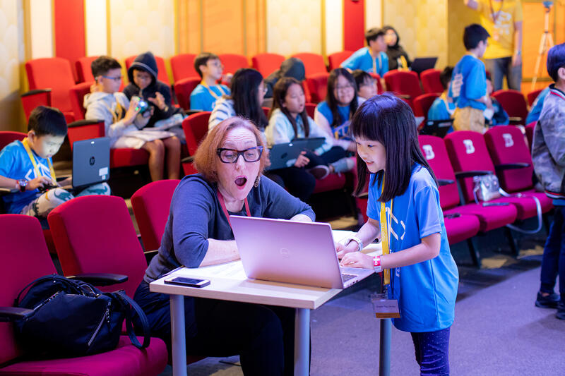 Judge evaluating student project at CodeFest hackathon