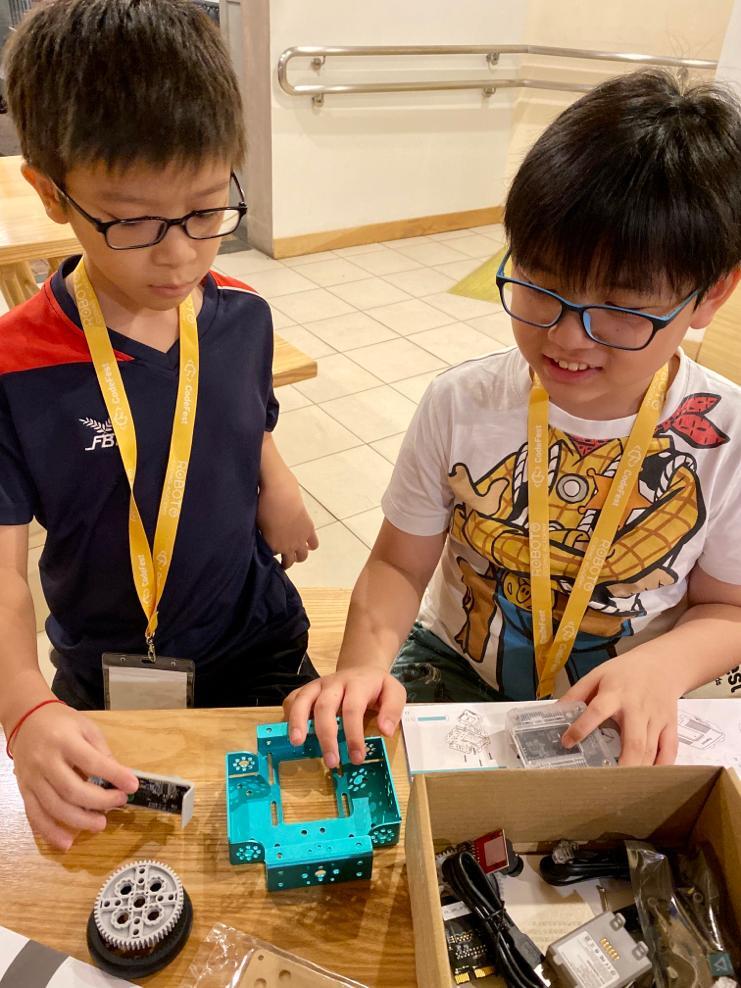 Kids assembling robot kits at CodeFest workshop
