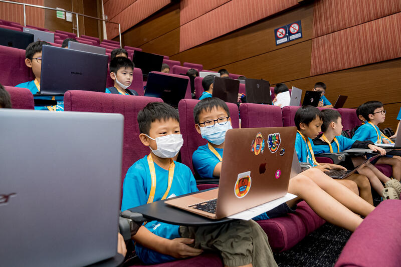 Kids working on laptops at CodeFest hackathon Singapore