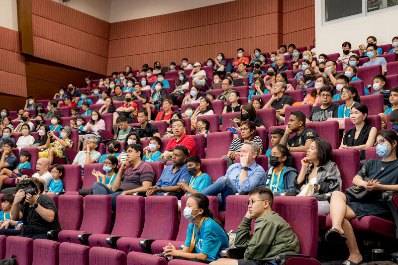 Parents and kids watching CodeFest competition presentations