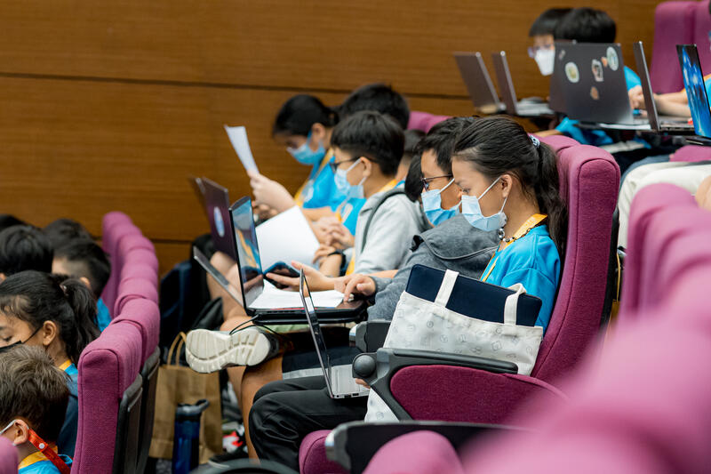 Students coding on laptops at CodeFest hackathon