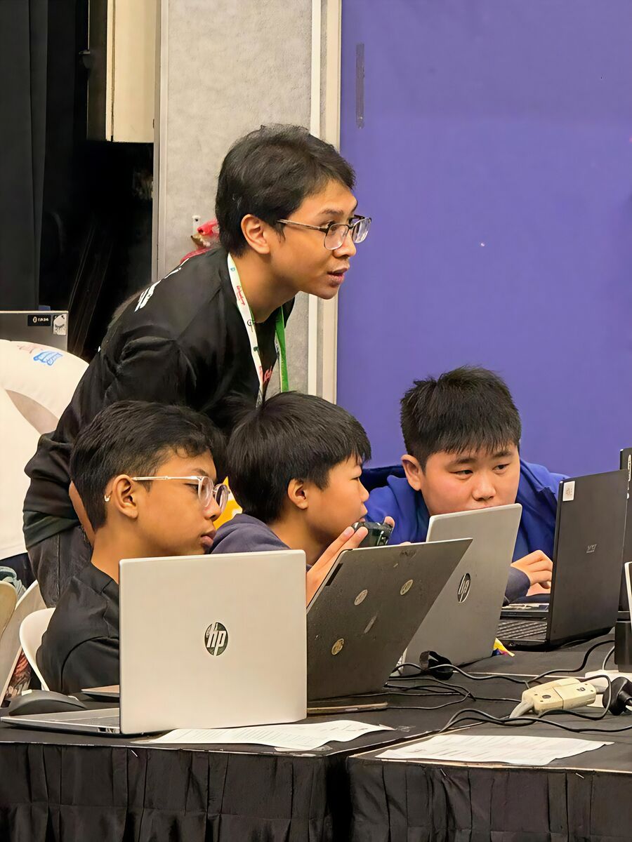 Coach guiding students during RoboCup 2026 competition