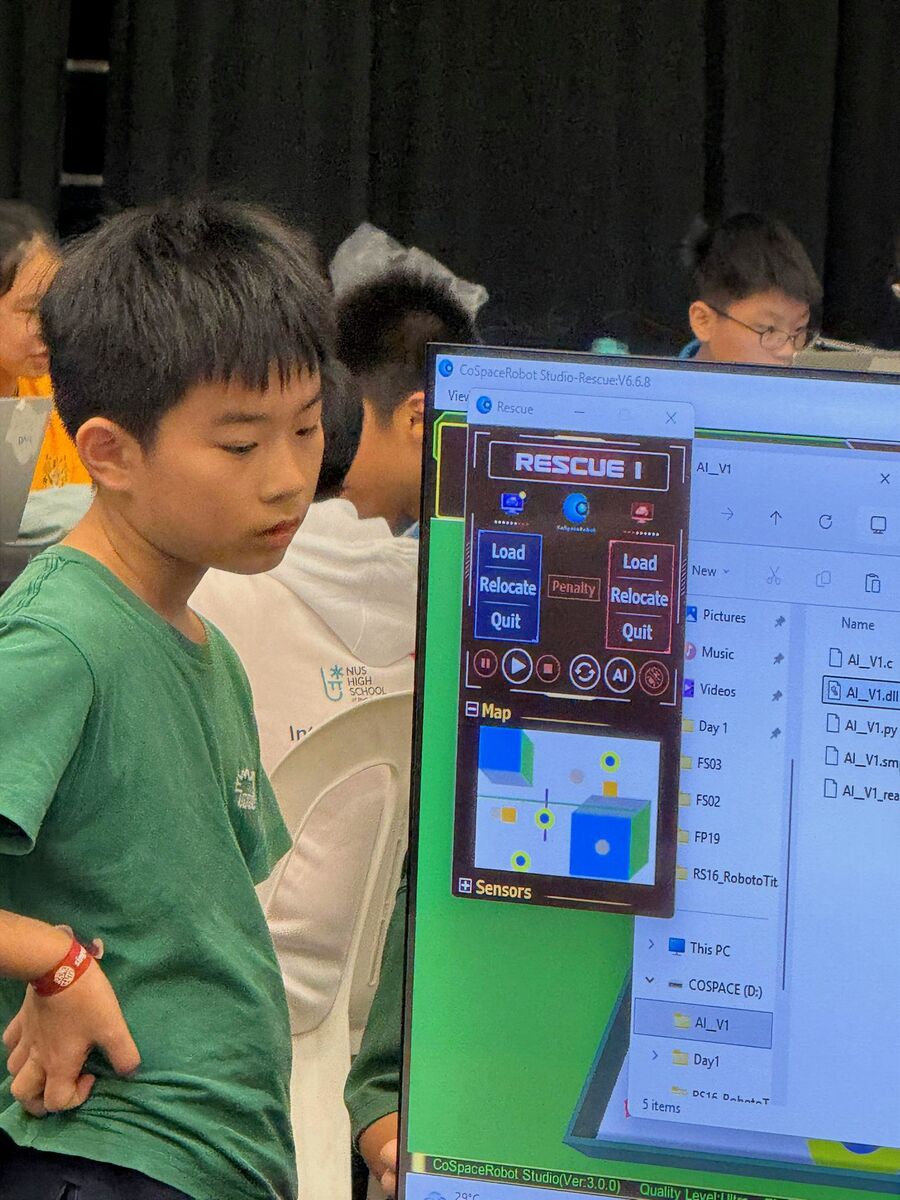 Student next to CoSpaceRobot Studio display at RoboCup 2026