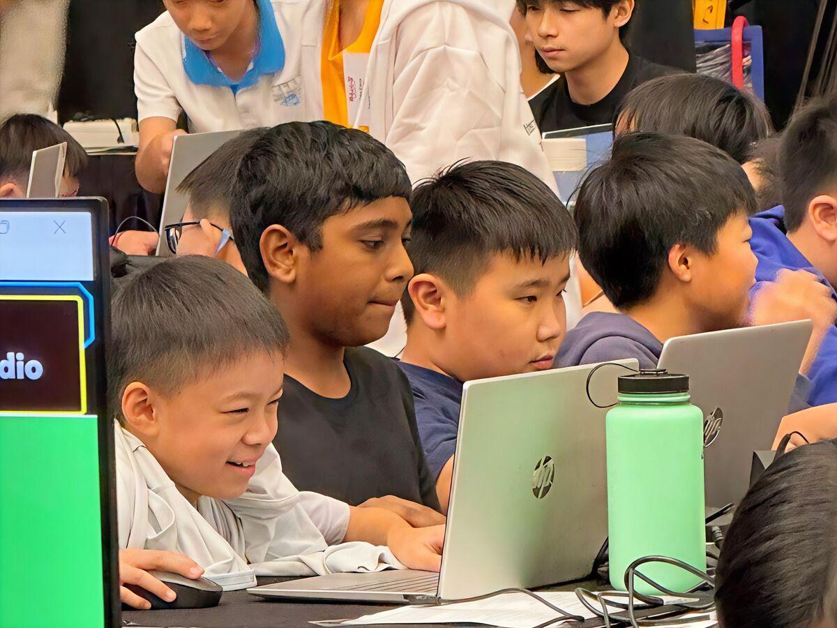 Students coding together at laptops during RoboCup 2026