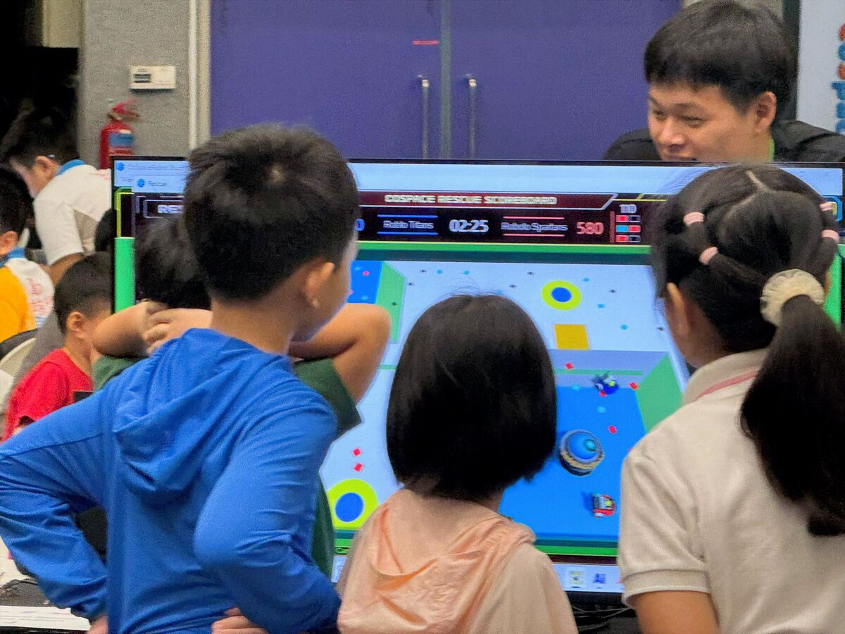 Students watching CoSpace Rescue match on display