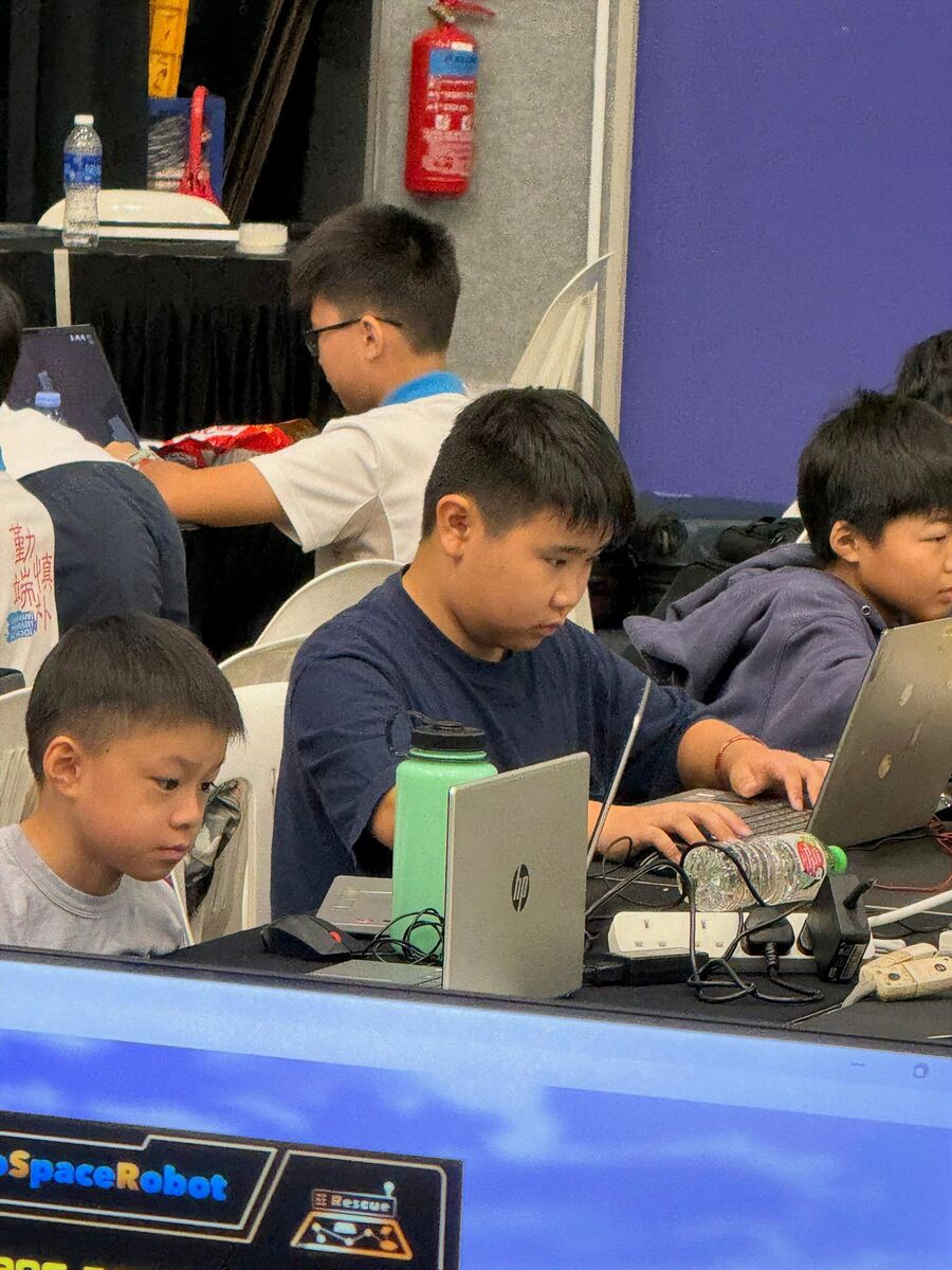 Students working on laptops during RoboCup 2026 competition