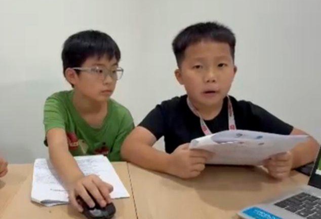 Two students reviewing competition strategy