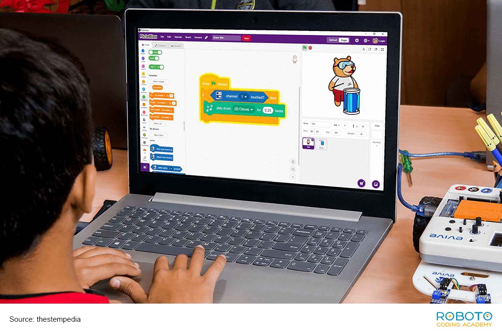 Image of a kid using scratch programming