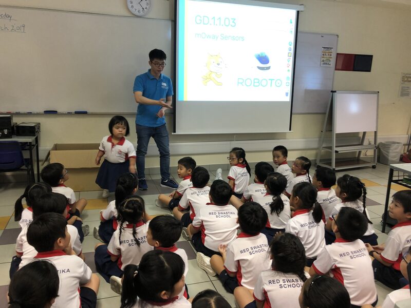 Students building and programming robots in class
